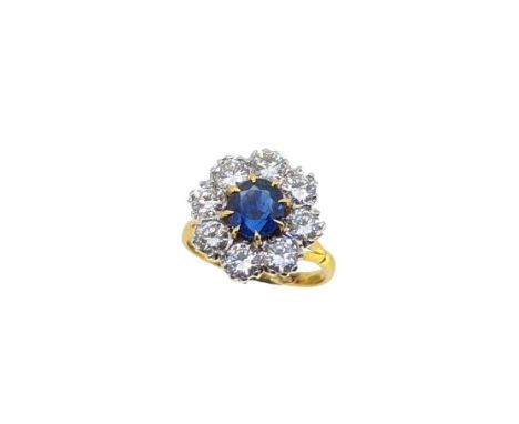 A sapphire and diamond cluster ring, claw set oval faceted sapphire, approximately 7.6 x 7 x 4.2mm, estimated approximate wei