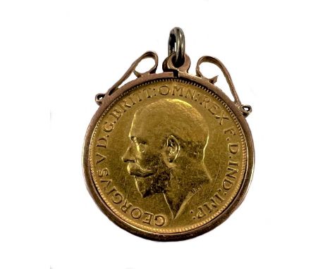 A George V sovereign in a pendant mount, dated 1911, the simple scroll topped mount with jump ring, one scroll stamped '9ct',
