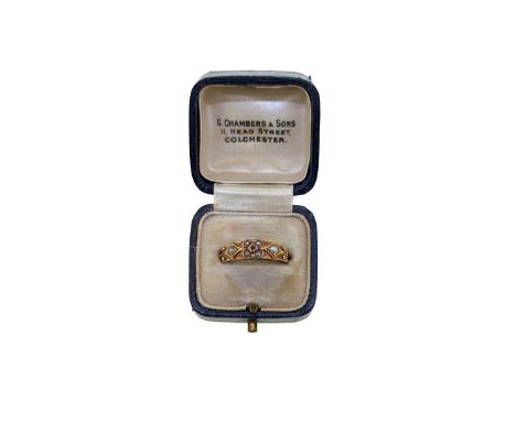 An early 20th century ruby and split pearl ring, tapered band with a central ruby surrounded by split pearls, and flanked by 
