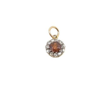 A zircon and diamond pendant, claw set cushion shaped brown zircon, approximately 6.5 x 6.3mm, surrounded by eleven rose cut 