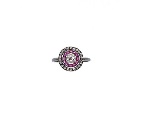 An Art Deco ruby and diamond target style ring, central rubover set old brilliant cut diamond, estimated approximate weight 0