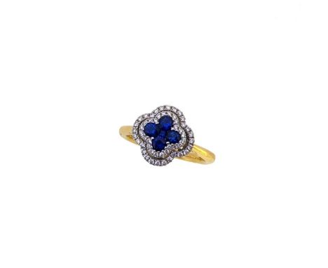 An 18ct gold sapphire and diamond cluster ring, central invisibly set square faceted sapphire and four round faceted sapphire