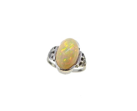 An opal and diamond dress ring, oval cabochon opal, approximately 15.75 x 10.4mm, estimated approximate weight 8.10ct, flanke