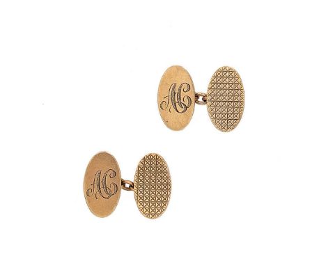 A pair of late 20th century 9ct gold cufflinks, oval panels, one with an engine turned pattern, and one with engraved initial