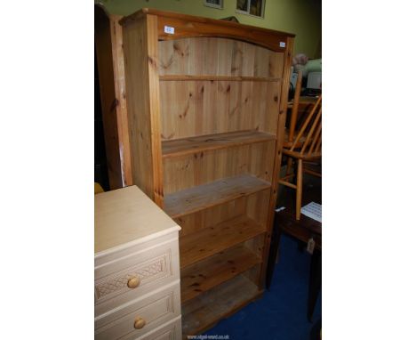 A pine shelf unit having six shelves, 32" wide x 11" deep x 69" high.