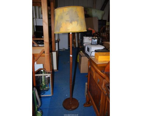 A wooden standard lamp with shade.