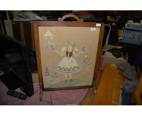 A fabric embroidered fire screen.