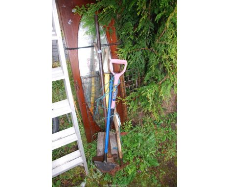 A shovel, pick axe, rake and ground metal compactor