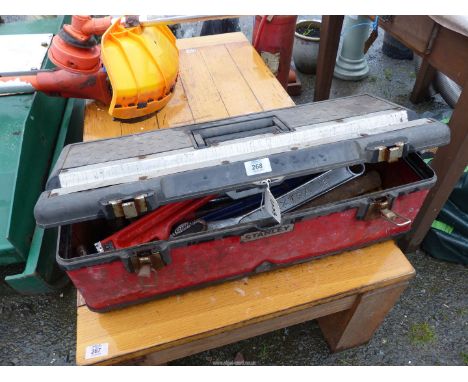 A toolbox containing large stilsons, bolster chisels, lump hammer, combination spanners etc.