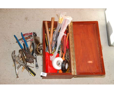 A wooden box containing various tools, pipe pliers, copper pipe molegrips, etc.