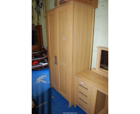 A light Oak finished wardrobe.