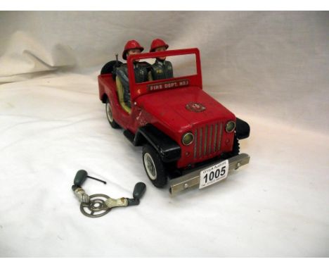 A vintage Nomura battery operated fire department Jeep, untested, base is loose 
