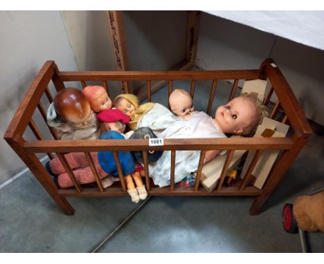 A vintage wooden dolls cot and contents COLLECT ONLY 