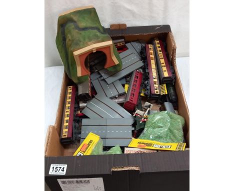 A box containing various OO scale Hornby railway carriages and other models train accessories 