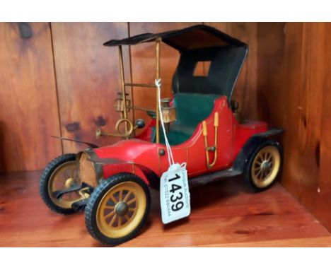 A vintage lighter in the form of a tinplate veteran car, possibly Japanese 