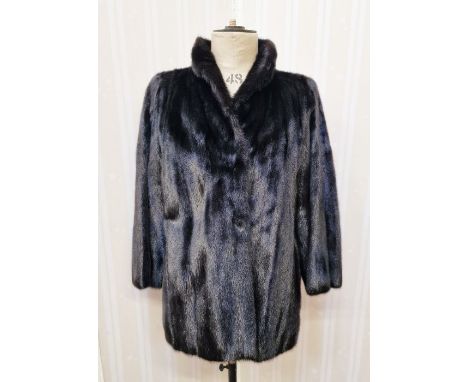 A vintage black saga mink three quarter length with bell sleeves, black satin lining embroidered with pleated detail size 12 