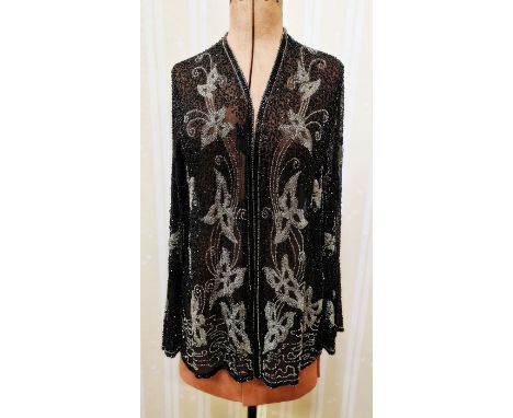A vintage black chiffon jacket embroidered with small square glass beads and faux jet, elaborate floral detail to the back, a