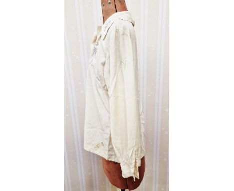 A silk embroidered Chinese style three quarter length jacket embroidered with figures, the faces picked out in black cotton d
