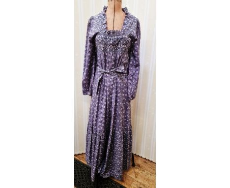An early 1970's purple maxi dress with pintucked bodice and frilled neckline, elasticated cuffs, with a tie back belt labelle
