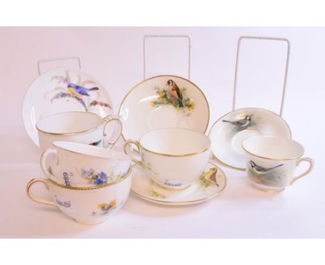 A Royal Worcester cup and saucer, painted a Wagtail, signed W Powell, two other cups and saucers, another cup with assorted s