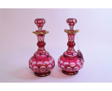 A pair of late 19th century ruby flashed glass scent bottles, with gilt decoration, 18 cm high (2)
