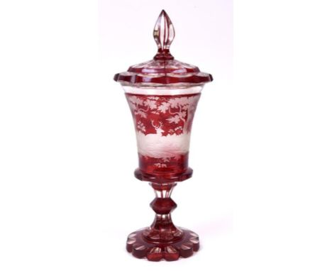 A Bohemian ruby flashed glass goblet and cover, decorated stags, deer and trees, 32.5 cm high  See illustration 