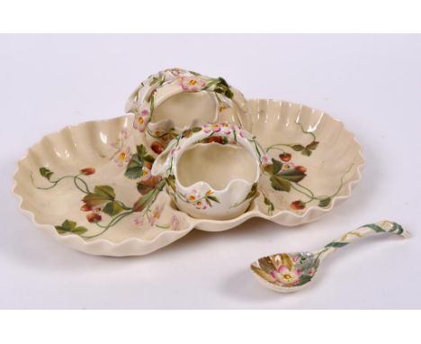 A George Jones Crescent China pottery strawberries and cream set, comprising a stand, sugar bowl, cream jug and a ladle, deco