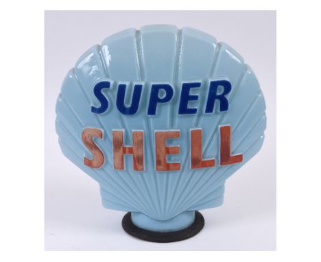 A Super Shell blue glass clam shell petrol pump globe, with rubber collar, some fading, 44 cm high  See illustration