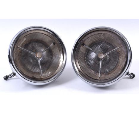 A pair of Lucas P100 headlamps, with bullseye lenses and chrome shells, signs of light pitting, 30 cm diameter, and two spare