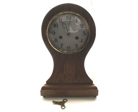 A mahogany inlaid chiming mantle clock. 34cms h. 