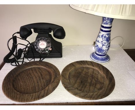 Reproduction black telephone with silver coloured dial together with blue and white ceramic lamp + shade and two oak plates. 
