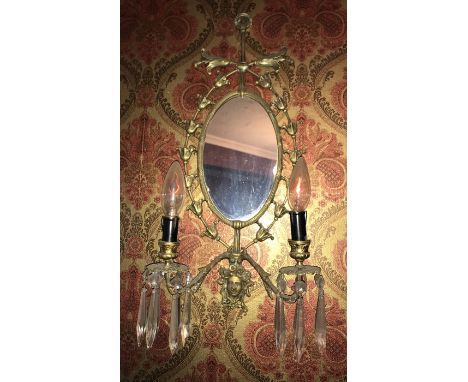 A pair of brass mirror double light fittings. 