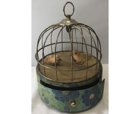 A 1960's birdcage music box, plays the theme from 'Love Story' as a bird swings back and forth. 23cms h. The metal cage has f