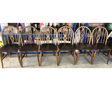 Six Ercol dining chairs each with a hoop stick back with a central splat. 