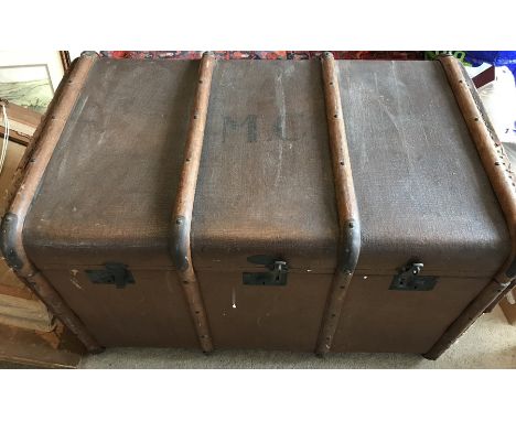 A wooden bound vintage trunk, MC to the top. 