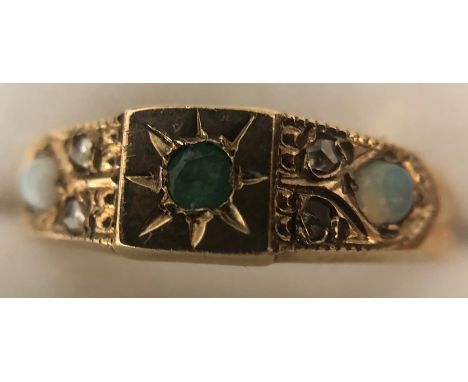 A 9 ct gold ring set with opals, diamonds and emerald. Size O. 2gms. 