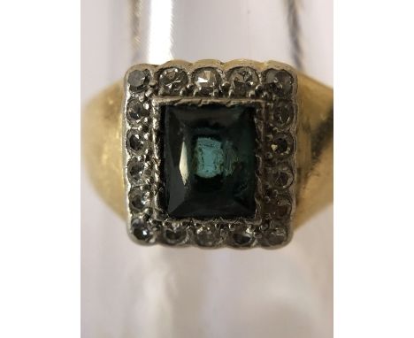 An emerald and diamond ring set in yellow metal, tested as 18ct. Size S. 