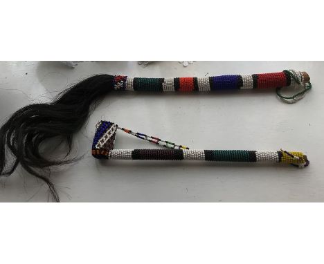 African beadwork whip with horse tail and beadwork covered pipe. 