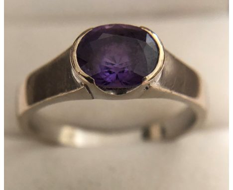 An 18ct white gold ring set with single amethyst, size W, 6.5gms. 