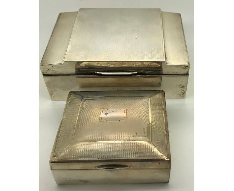 Two engine turned silver cigarette boxes, Walker and Hall 1938, 14 x 9.5cms and Birmingham 1934. 