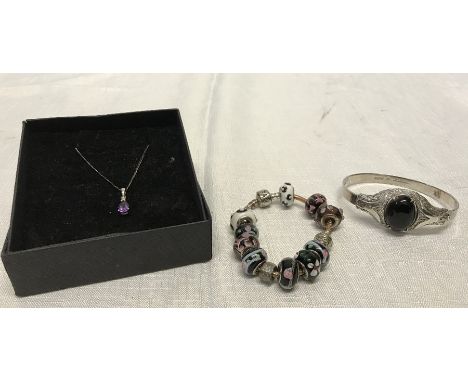 Pandora bracelet with ten bead charms stamped 925, a silver and gold pendant set with purple stone on a chain and a hallmarke