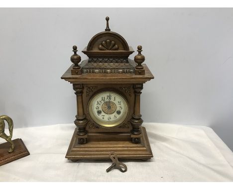 Walnut cased mantle clock, enamel face with brass decoration, HAC Wurttemberg 14 day strike, with key. 43 cms h to finial tap