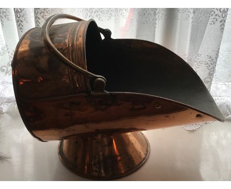 A 19thC copper coal helmet. 56 l x 34cms h. 