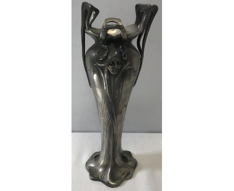 An Art Nouveau pewter vase. 23cms h. A maidens face depicted to each side. Condition ReportSlightly a/f to top.&nbsp;