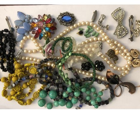 A quantity of costume jewellery in a jewellery box to include sterling silver and enamel brooches, silver and blue glass bead