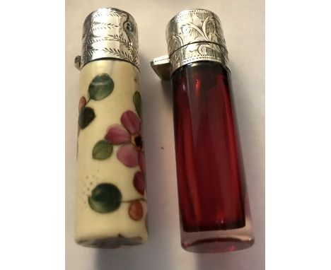 A cranberry glass and silver topped scent bottle with stopper, 7.5cms h Birmingham 1904 together with a ceramic and white met