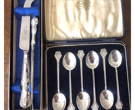 A boxed set of 6 engine turned silver teaspoons, London 1934 with a silver handled button hook and a silver handled knife. Co