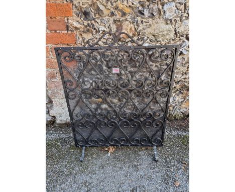 A black wrought iron firescreen,&nbsp;71 x 56cm. 
