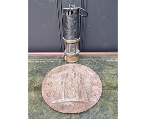 An old brass miner's lamp;&nbsp;together with a cast iron 'Chichester' plaque, 22.5cm diameter.&nbsp; 