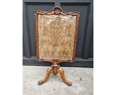 A Victorian carved rosewood and embroidered fire screen, 106.5cm high.&nbsp; &nbsp; 